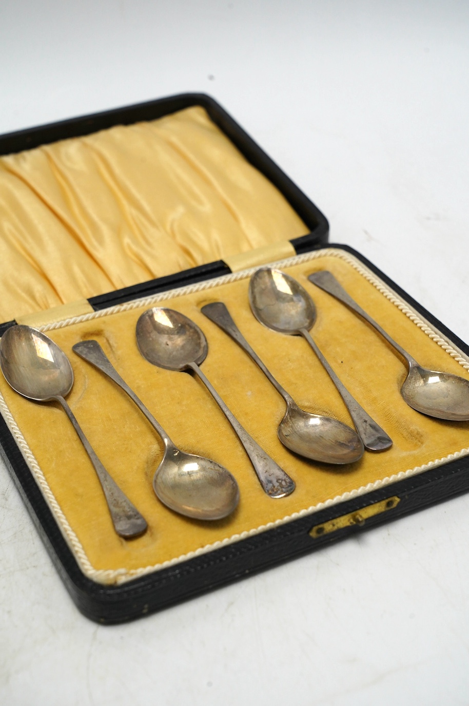 Sundry small silver including cased sets and loose flatware, condiments, a white metal tea strainer and peacock menu holders, etc. Condition - poor to fair